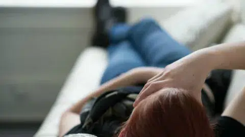 teenager lying with hand on forehead 600