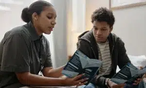 a support worker talking to a teenager boy in a childrens home seventyfour adobe stock 1936619518