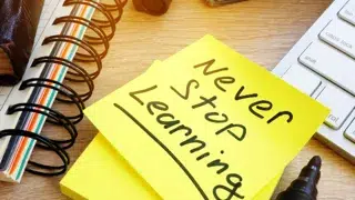 post it note with never stop learning on desk vitalii vodolazskyi adobestock 190750836