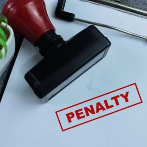 the word penalty stamped onto a piece of paper on a clipboard in red syahrir adobe stock 864757299