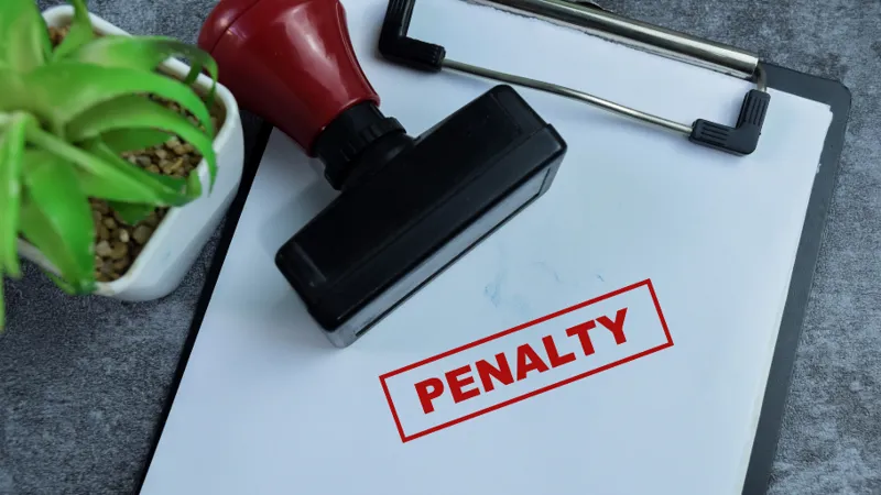 the word penalty stamped onto a piece of paper on a clipboard in red syahrir adobe stock 864757299